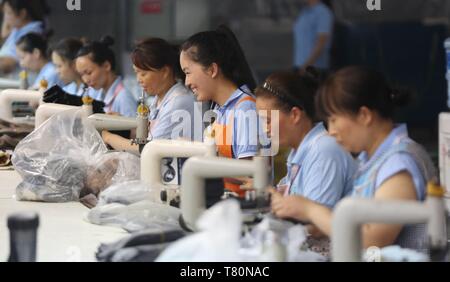 (190510) - Peking, 10. Mai 2019 (Xinhua) - Arbeitnehmer machen Schuhe auf einem Fließband in einer Schuhfabrik in Wuzhi Grafschaft von der Central China Provinz Henan, Aug 11, 2017. (Xinhua / Feng Xiaomin) Stockfoto