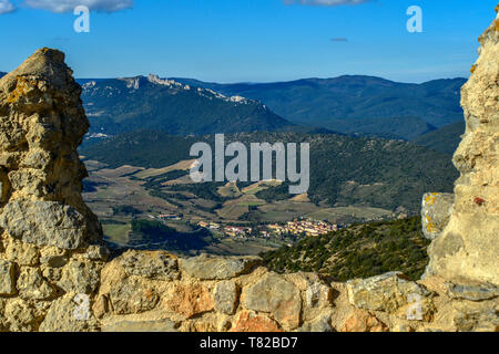 Die Ansicht zum Château Peyrepertuse, aus den Ruinen der mittelalterlichen Queribus Burg, in der Pyrenees Orientales, Frankreich. Quéribus Dorf im Vordergrund. Stockfoto