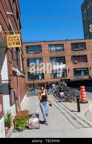 Kanada, Quebec, Montreal, Plateau-Mont-Royal, Mile-End, Saint-Viateur Straße, Atmosphäre, einen Fitnessraum, eine junge Frau lächelnd auf dem Telefon Stockfoto