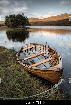 Ein ausgesetztes Holz- Boot vertäut am Ufer des Loch Awe, Assynt, Sutherland, Schottland Stockfoto