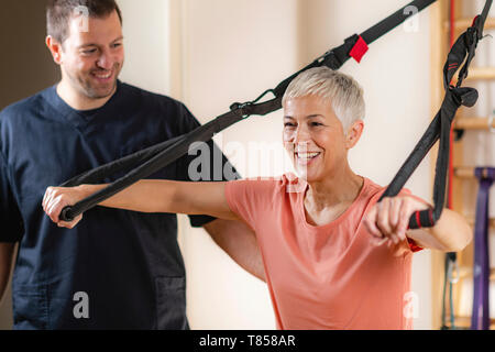 Ältere Frau mit Personal Trainer Stockfoto
