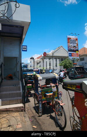 Bandung, Indonesien - 28. Februar 2013: Becak oder Indonesische cycle rickshaw in asiatischen Afrikanische Straße in der Stadt Bandung, Indonesien Stockfoto