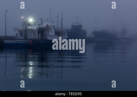 Ein Abend Nebel rollen in vom Atlantischen Meer und Decken Hout Bay Hafen im Nebel auf der Kap Halbinsel, in der Nähe von Kapstadt in Südafrika Stockfoto