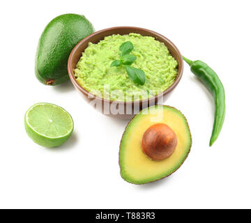 Schüssel mit leckeren Guacamole und Zutaten auf weißem Hintergrund Stockfoto