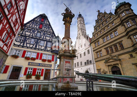 Marktplatz, ein Platz, der von mittelalterlichen Fachwerkhäusern gesäumt ist, und St. Georgs Brunnen über Herterichs Brunnen. Rothenburg Ob Der Tauber, Deutschland Stockfoto