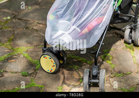 Kind im Kinderwagen mit schützenden Netz während Spaziergang abgedeckt. Kinderwagen mit Anti-mücken-Abdeckung. Midge-Schutz für Kinder während Outdoor Stockfoto