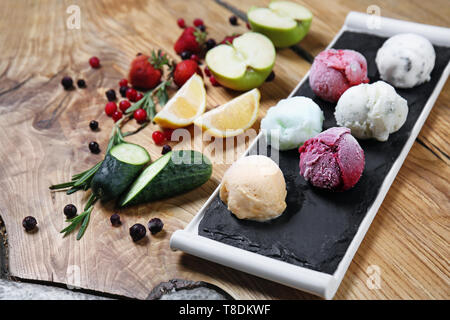 Schiefer Teller mit leckeren Eis und andere Zutaten auf Tisch Stockfoto