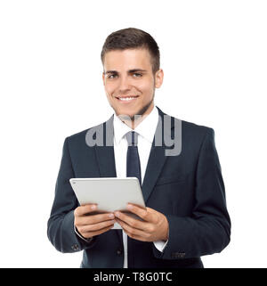 Hübscher junger Mann im eleganten Anzug mit Tablet-PC auf weißem Hintergrund Stockfoto
