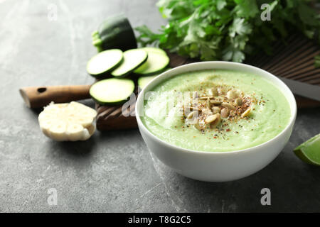 Lecker zucchini Suppe mit Kürbiskerne in Schüssel auf dunklen Tabelle Stockfoto