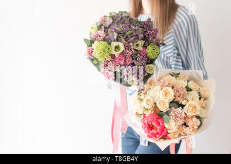 Zwei schöne Sträuße Gemischte Blumen in womans Hände. Die Arbeit der Florist in einem Blumenladen. Zarten Pastelltönen. Frische Schnittblume. Stockfoto