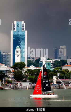 Segeln in der Bucht, ein DBS Segelboot Segel Vor Der Merlion Park, Singapur, Südostasien Stockfoto