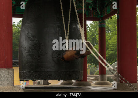 Detailansicht auf einem traditionellen koreanischen cloche, Glocke, mit der Ausrüstung in der Bell Pavillon in der Yongdusan Park. Busan, Südkorea, Asien. Stockfoto