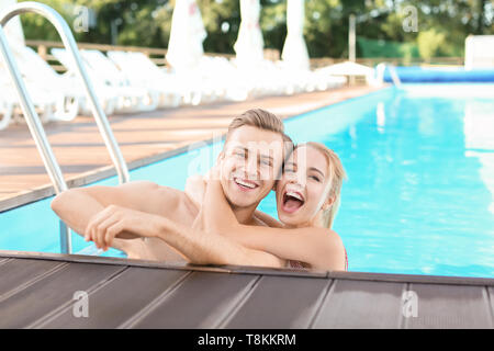 Glückliches junges Paar im Pool im Resort ruht Stockfoto