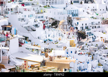 Fira, Freece - April 26, 2019: Panorama der Stadt, Dorf in der Santorini Insel mit weißen und blauen Häuser und Menschen Stockfoto