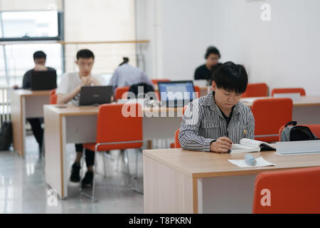 (190514) - Peking, 14. Mai 2019 (Xinhua) - Ratjirot Aekkawat Studien in einem Klassenzimmer der Peking Universität in Beijing, die Hauptstadt von China, 12. Mai 2019. Ratjirot Aekkawat ist von gemischten Blut aus China und Thailand. Er kam in China als Junior student zu studieren und jetzt ist er ein Nachdiplomstudium in der Peking Universität. Er spricht immer über seine Erfahrungen in China mit Verwandten und Freunden. Er hat die Entwicklung Chinas in den letzten Jahren erlebten, in der die Umwelt und die lokalen Regierungen die Effizienz erheblich verbessert wurden. Chinesische und thailändische Kulturen sind influe Stockfoto