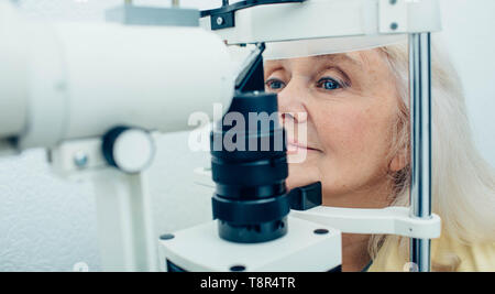 Ältere Frau tun Auge Test mit Auge Ausrüstung Stockfoto