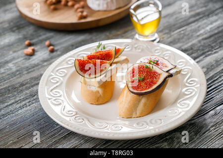 Leckere Sandwiches mit reifen Feigen- und Brie Käse auf dem Teller Stockfoto