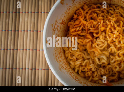 Schüssel mit chinesischen Ramen Nudeln mit Ketchup. Ansicht von oben. Stockfoto