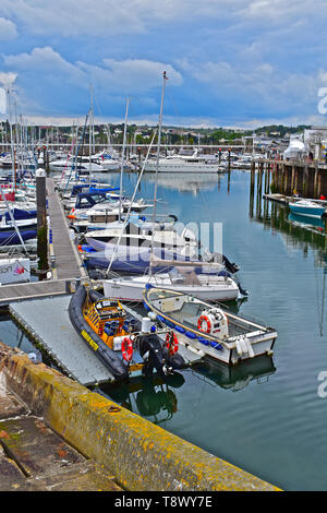 Ein Blick über den Inneren Hafen/Marina bei Torquay mit Yachten bei moorings. Ruhe Stille Wasser mit Reflexionen von Booten und Gebäude auf dem Hügel. Stockfoto