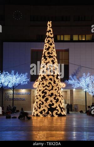 Konische Weihnachtsbaum mit Mond Dekorationen vor dem Rathaus (Ayuntamiento) Nachts, Fuengirola, Spanien. Stockfoto