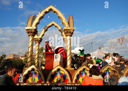 Drei Könige Parade mit Melchor saß auf seinem Schlitten Süßigkeiten werfen für die Öffentlichkeit, La Cala de Mijas, Spanien. Stockfoto