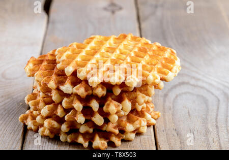 Vertikalen Stapel von frischen runden Wafer auf alten rustikalen Holztisch. Mittagessen Nachtisch. Kopieren Sie Platz. Stockfoto