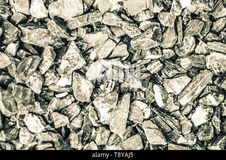 Hintergrund und die Textur von kleinen Steinen rock. Zerkleinert kies Textur, Outdoor rustikalen starkes Gefühl Stockfoto
