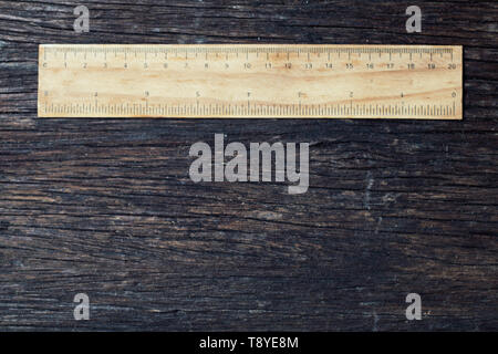Holz- Herrscher in Zentimeter und Zoll auf alten Holz rustikale Hintergrund Natur eco Umwelt Konzept Idee Stockfoto