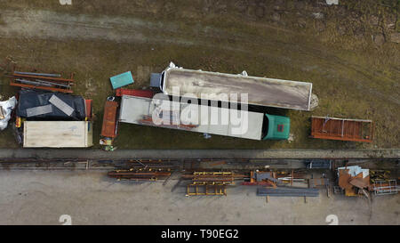 Schrott Maschinen und Lastwagen auf Hof, von oben nach unten Luftbild Stockfoto