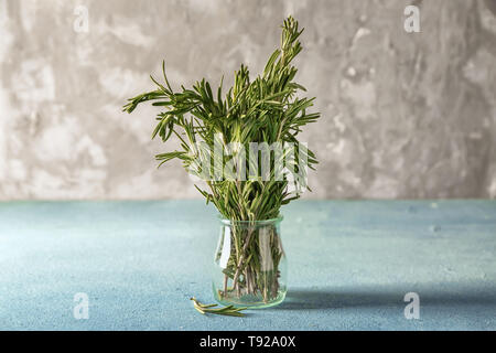 Glas Glas mit frischem Rosmarin auf Tisch Stockfoto