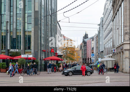 Fußgänger auf der Straße neben der alten Gebäude im Central Business District und City Square in der Nähe Augustusplatz in der Innenstadt von Leipzig, Deutschland Stockfoto