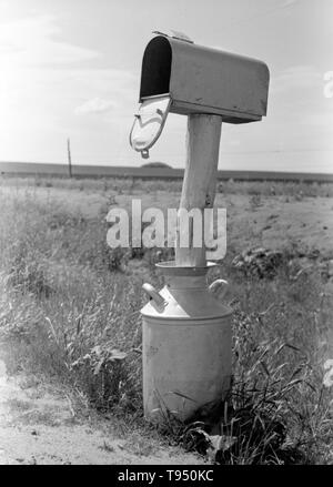 Titel: 'Mail-Box kann in der Nähe von Hydro, Oklahoma in der Milch festgelegt." Vor der Einführung des ländlichen Kostenlose Lieferung (RFD) von der Post im Jahr 1896, viele ländliche Bewohner hatten keinen Zugang zu E-Mail, es sei denn Sie sie in einem Postamt viele Meilen entfernt von ihren Häusern gesammelt oder angestellt, ein eigenes Unternehmen zu liefern. Aus diesem Grund, Mailboxen nicht beliebt im ländlichen Amerika geworden, bis Bordsteinkante RFD Zustellung durch die Post war ein etablierter Service. Stockfoto