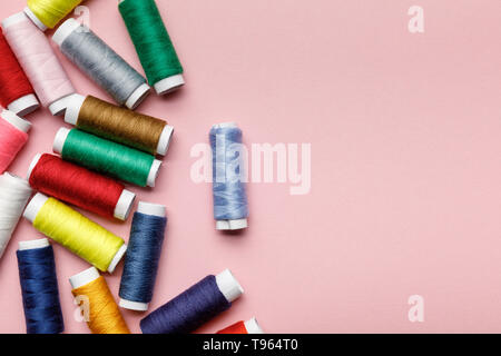 Blick von oben auf die verstreut bunte Thema Spulen isoliert auf Rosa mit Kopie Raum Stockfoto