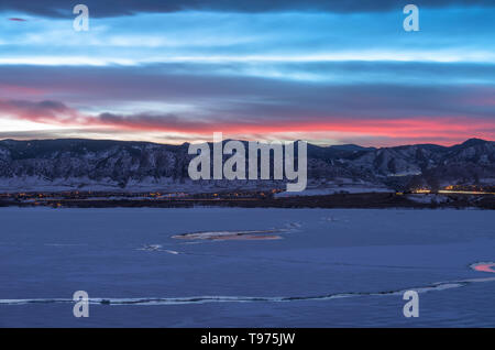 Winter Sonnenuntergang am Denver Front Range - Sonnenuntergang Blick auf den zugefrorenen See und Schnee - Berge im Südwesten von Denver, Colorado, USA. Stockfoto