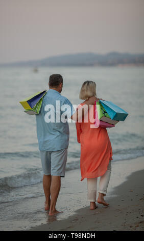 Ein Paar mittleren Alters ein Spaziergang entlang der Küste barfuß Stockfoto