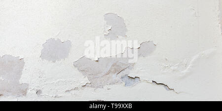 Alte verwitterte bemalte Mauer Hintergrund Textur. White dreckig geschält Pflasterwand mit aus fallenden Flocken von Farbe Stockfoto