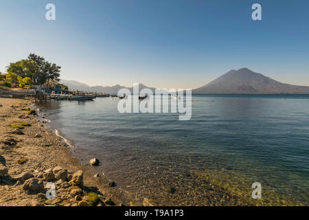 Atitlan See, Ufer, Boote und Vulkan im Hintergrund, in Panajachel, Guatemala Stockfoto