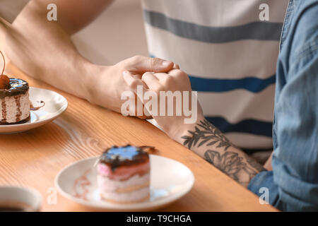 Liebevolle junge Paare während romantisches Date im Café Stockfoto