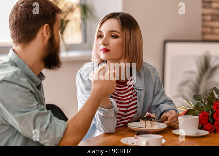 Liebevolle junge Paare während romantisches Date im Café Stockfoto