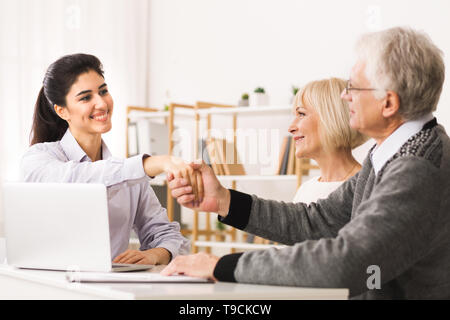 Gerne Reifes Paar Abdichtung Vertrag mit Finanzberater Stockfoto