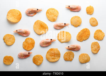 Leckere Chips und Garnelen auf weißem Hintergrund Stockfoto