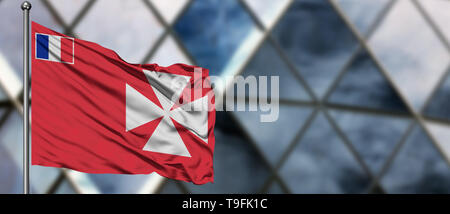 Wallis und Futuna Flagge im Wind gegen verwackelte, modernes Gebäude. Geschäftskonzept. Nationale Zusammenarbeit Thema. Stockfoto