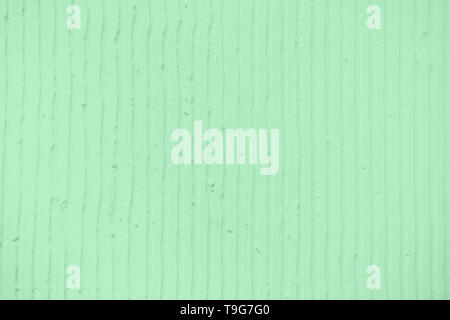 Detailansicht der Wand mit einem decorativetrendy Farbige mint Gips vertikale Linien und Streifen. Strukturierte Betonwand mit als Textur oder Hintergrund. R Stockfoto