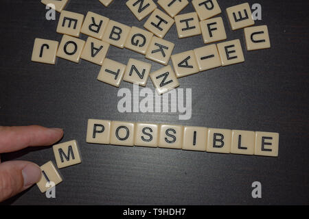 Fliese Briefe mit der Hand nicht möglich, auf einem schwarzen Hintergrund mit gemischten Buchstaben oben. Konzept für geschäftliche, persönliche oder andere Ziel-set Stockfoto
