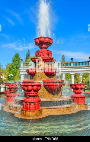 Novokuznetsk, Russland - 19. Mai 2019: alte Brunnen im Stadtpark. Kaltes Wasser aus Stein fünf Ebenen Brunnen am sonnigen Tag fließt. Konzept Stockfoto