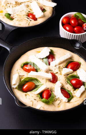 Essen Konzept steigende Teig für vegane Hausgemachte organische Focaccia in Skillet eiserne Pfanne auf schwarzen Hintergrund mit Kopie Raum Stockfoto