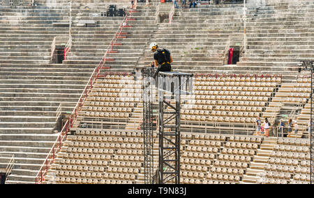 VERONA, ITALIEN - September 2018: Spezialist Rigger auf einem hohen Metall Beleuchtung gantry Zerlegen des Rahmens nach einem klassischen Konzert in Verona sind Stockfoto