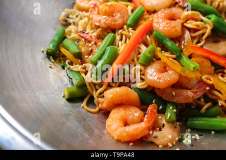 Chinesische Nudeln mit Garnelen und Gemüse im Wok, Nahaufnahme Stockfoto