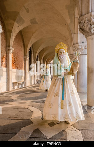 Porträt einer Feminine maskierte Person in einem schönen kreativen Kostüm, in den Arkaden des Dogenpalastes, Palazzo Ducale posing Stockfoto