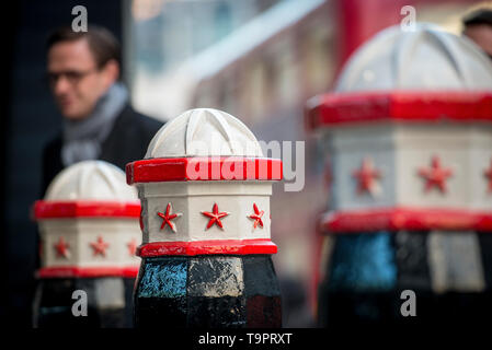 Die berühmte rote weiße und schwarze Eisenstadt London bollert und ein Stadtarbeiter pendelt auf seinem Weg ins Büro Stockfoto